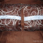 Sheer pillow covers to match curtains with blue ultrasuede trim and buttons over brown pillows