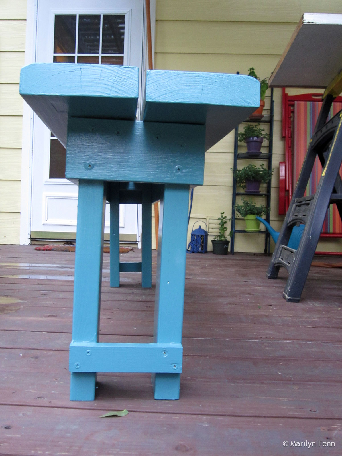 Narrow-stance garden bench - end view, painted