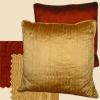 Silk pillows in shades of deep red-orange and gold