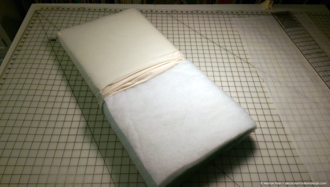 Cushion halfway inserted into muslin cover