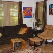 Added colorful pillows, sheer curtains, a new chair and ottoman, and a rolling coffee table